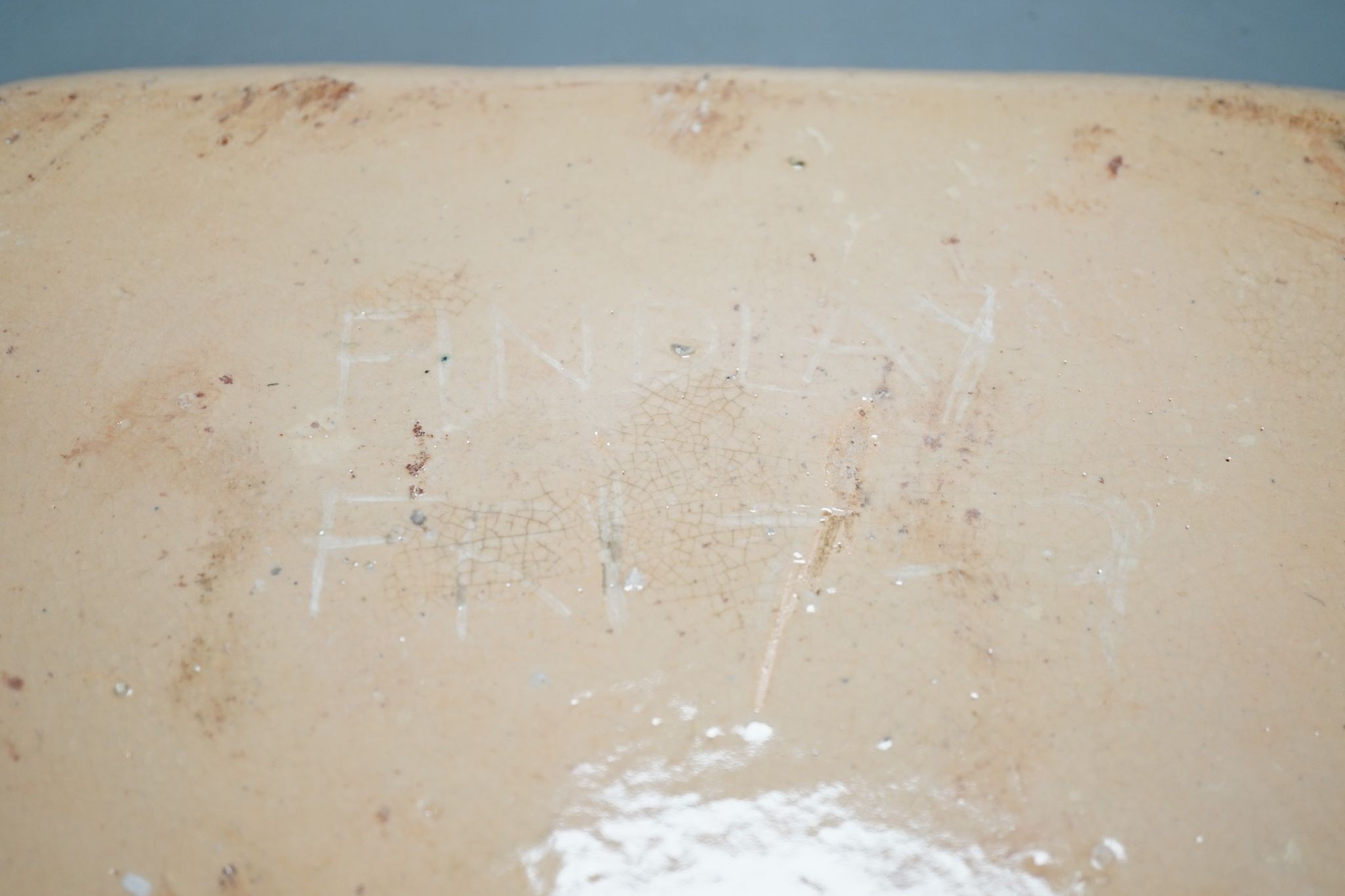 A slipware baking dish, indistinctly signed Findlay Fri(?), 37.5 cms wide.